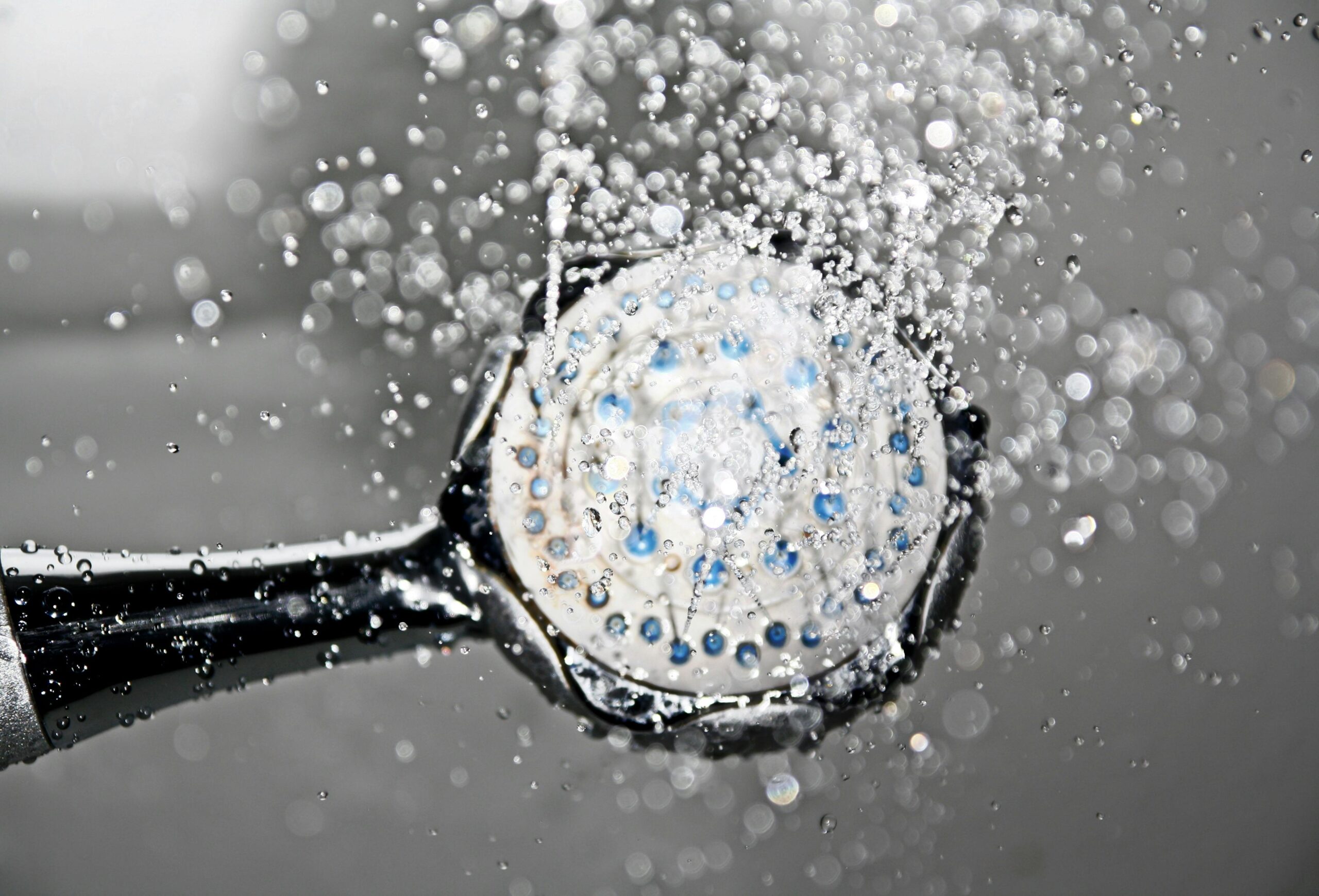 Close up of shower head with spraying water
